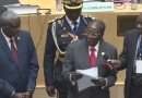 Zimbabwe President Robert Mugabe presents fundraising check of $1 million to the AU Summit